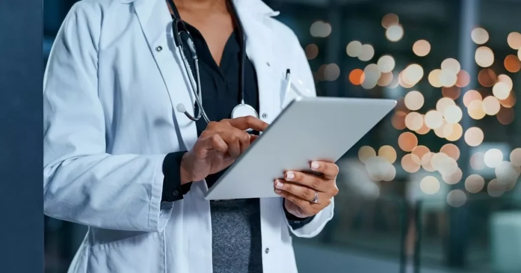 A doctor researches custom healthcare software trends 2025 for their hospital’s new app.