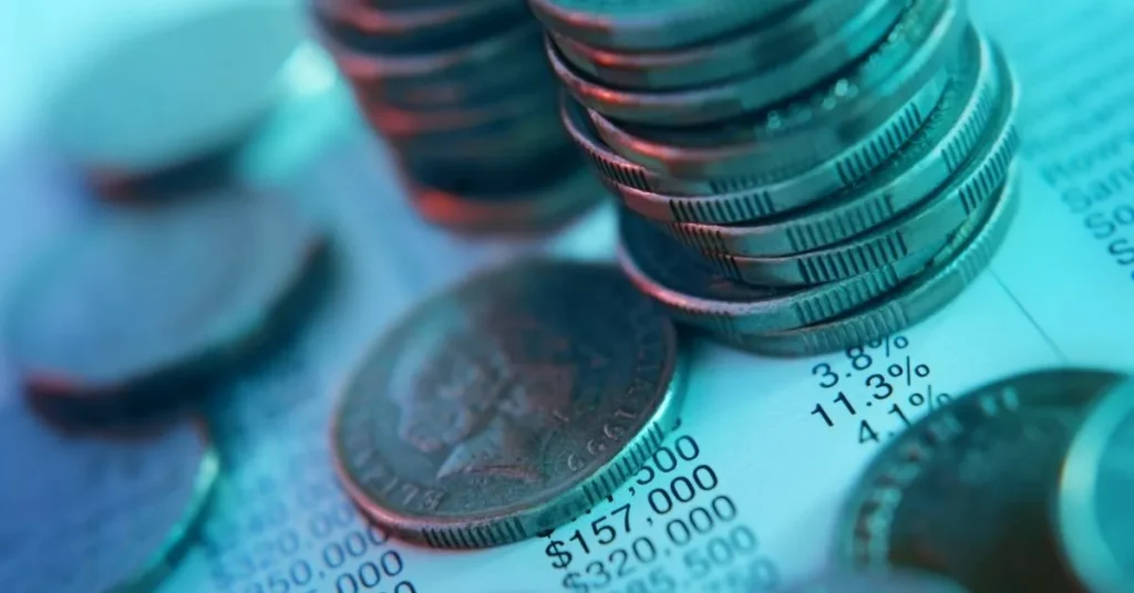 Hidden AI development costs in 2025 marked by coins and a list of numbers.