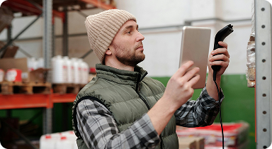 warehouse worker scanning inventory with tablet in logistics storage facility