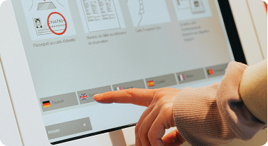 person using touchscreen kiosk for travel booking and digital interface navigation