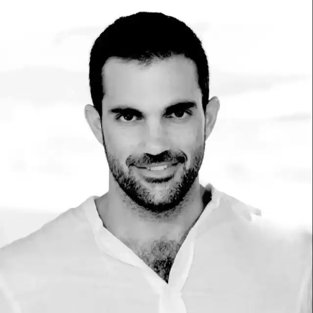 Professional portrait of a man in a business suit, likely for a corporate profile or website.